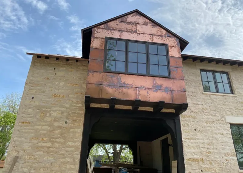 Copper metal panel facade on a stone building for Skylight Installation in Tigard